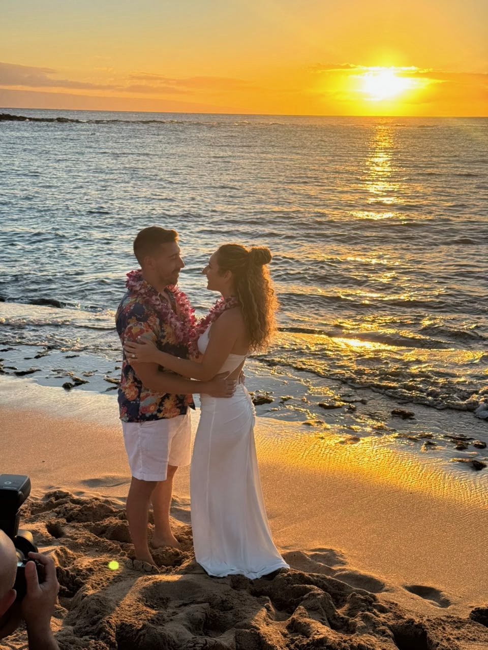 Foivos and Alexandra embracing on the beach at sunset