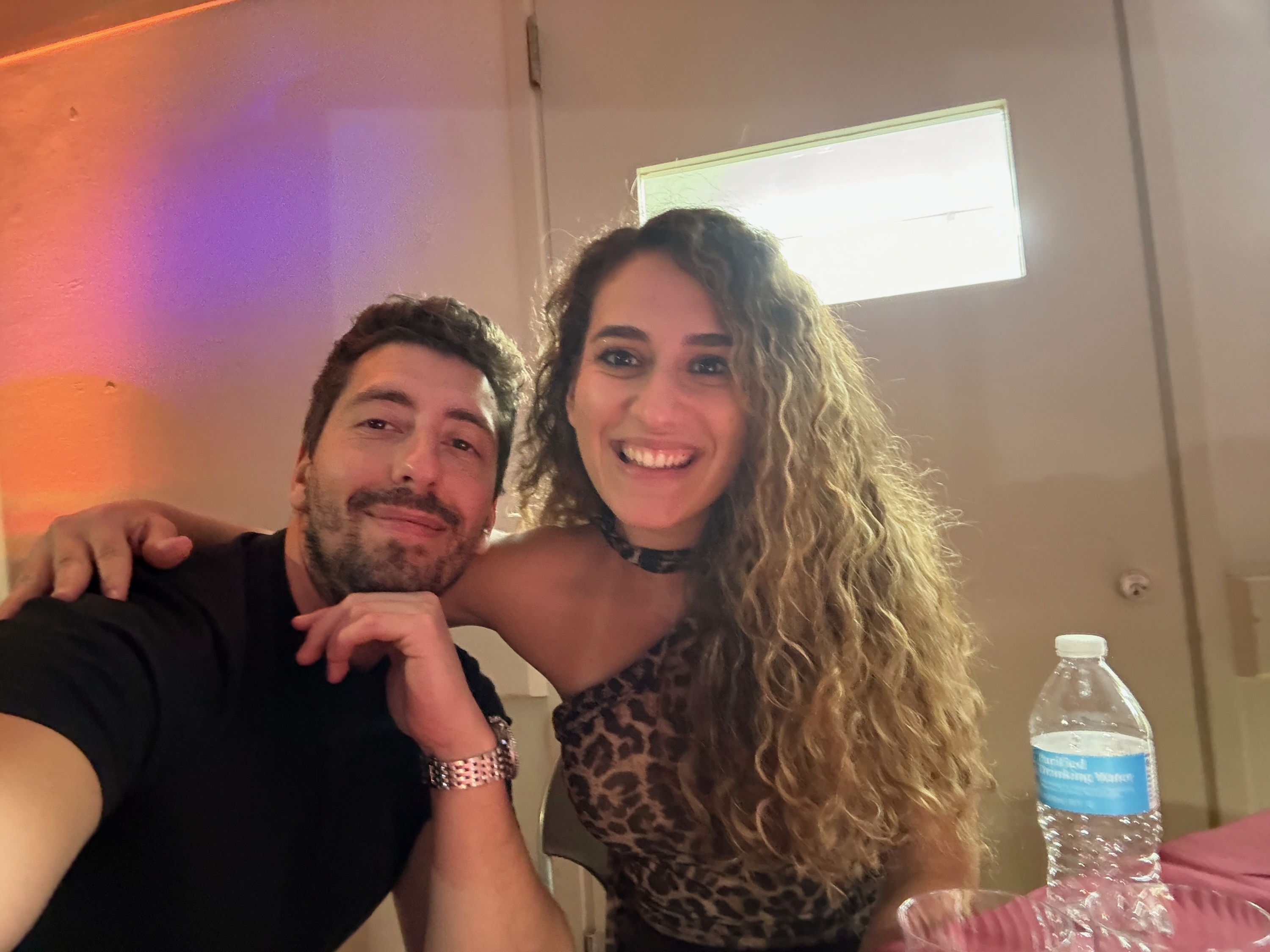Foivos and Alexandra smiling together at an evening celebration