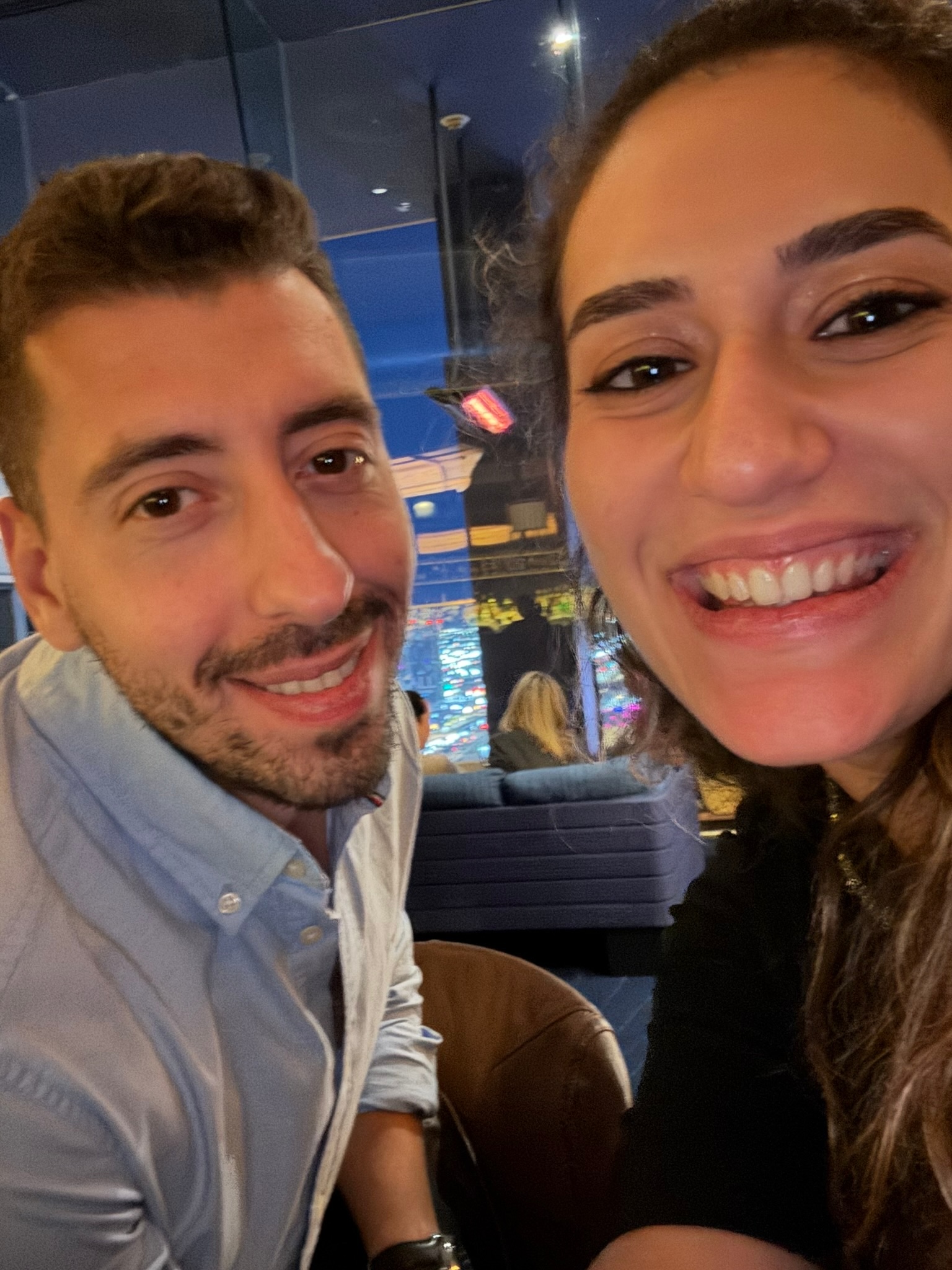 Foivos and Alexandra smiling together at a restaurant
