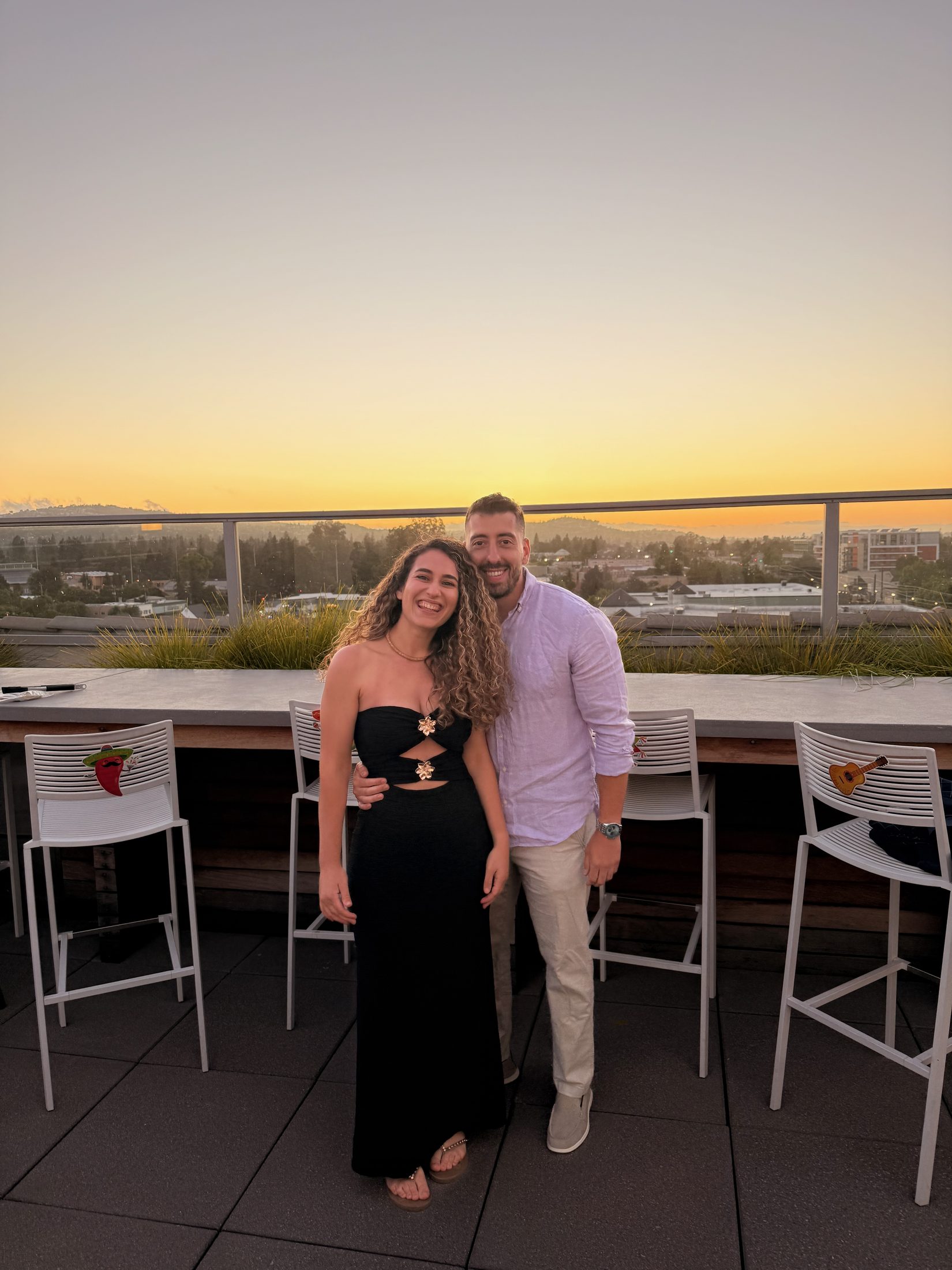 Foivos and Alexandra together on a rooftop at sunset