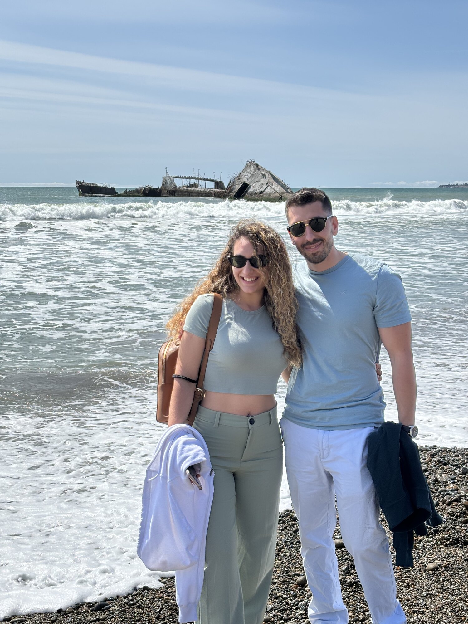 Foivos and Alexandra together on a rugged shore