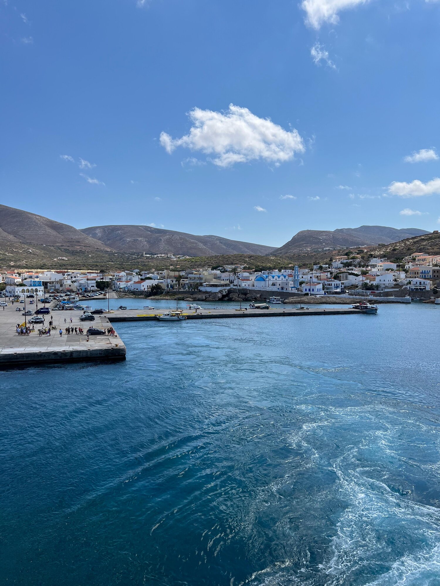 Fry harbour, its fishing boats and blue-domed church, seen from the sea